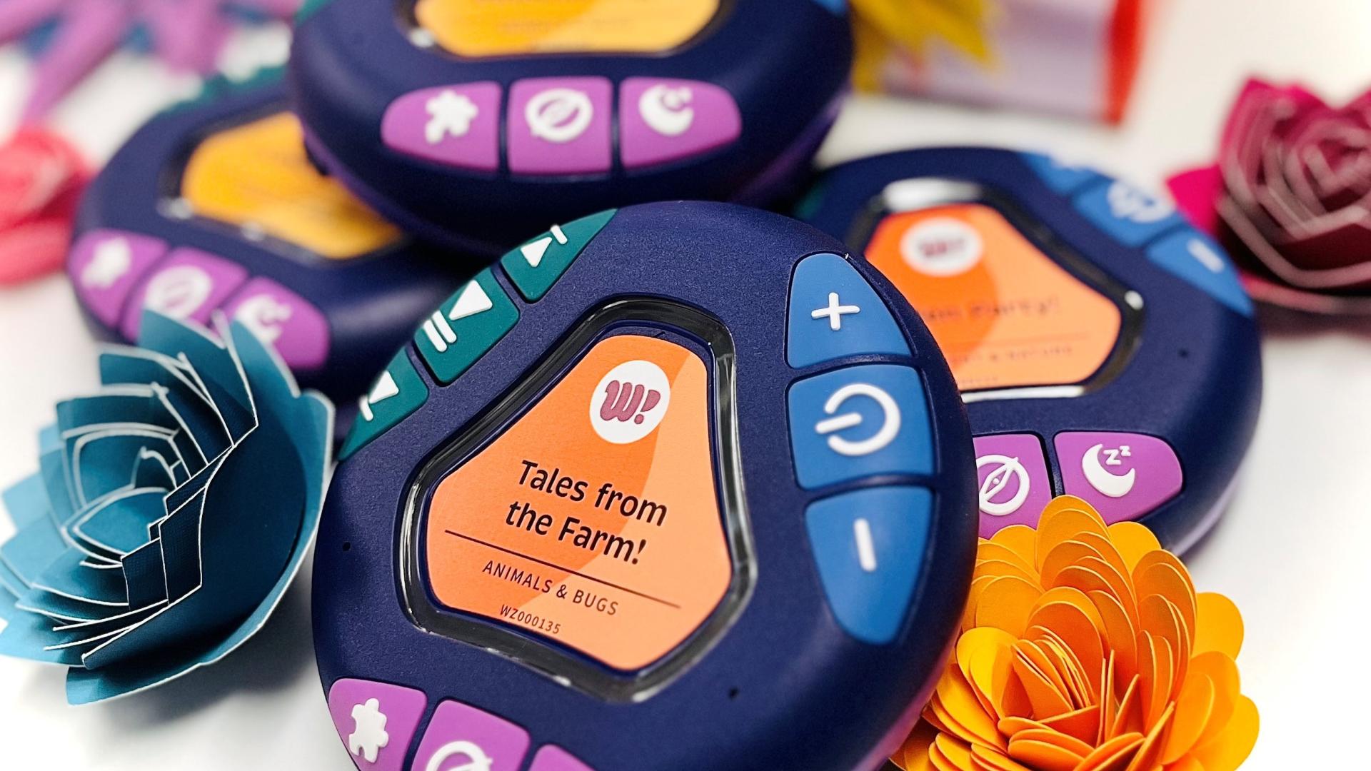 Small round electronic device with buttons and the words Tales from the Farm in the middle