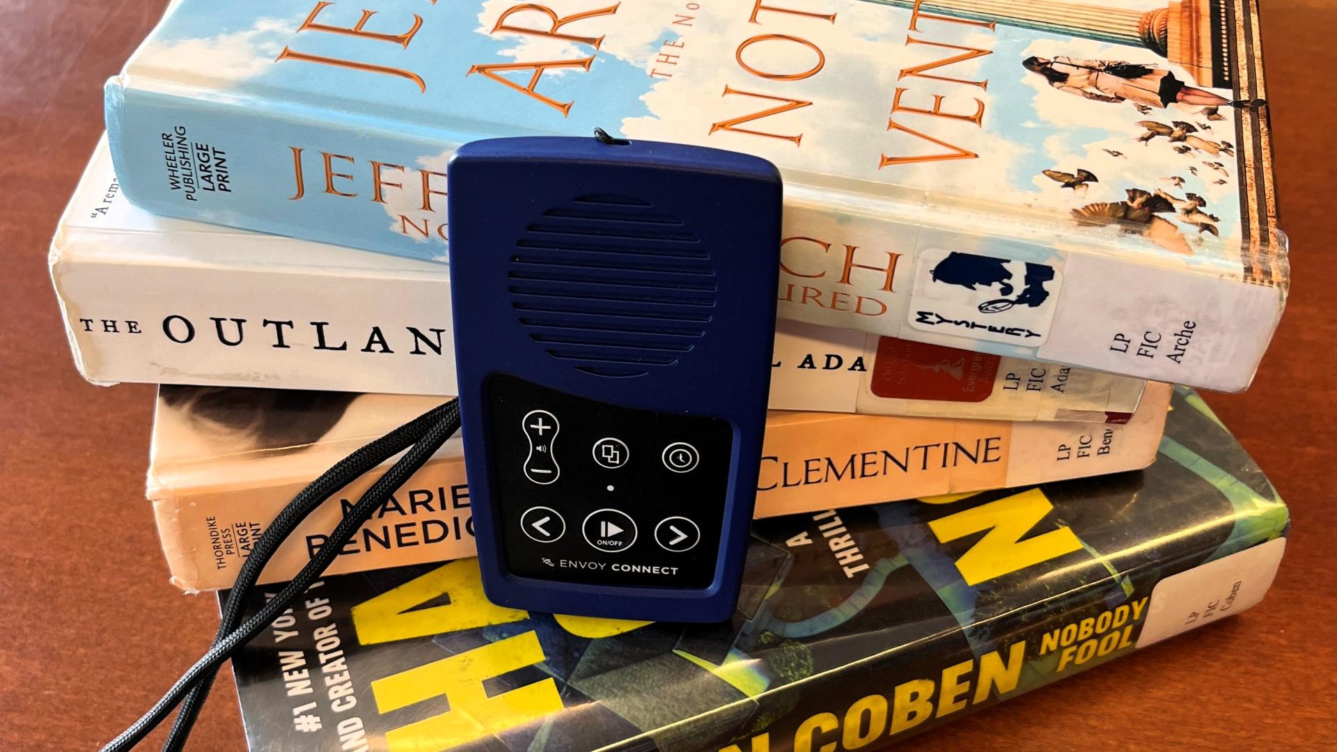 Small blue device with a built-in speaker and play buttons