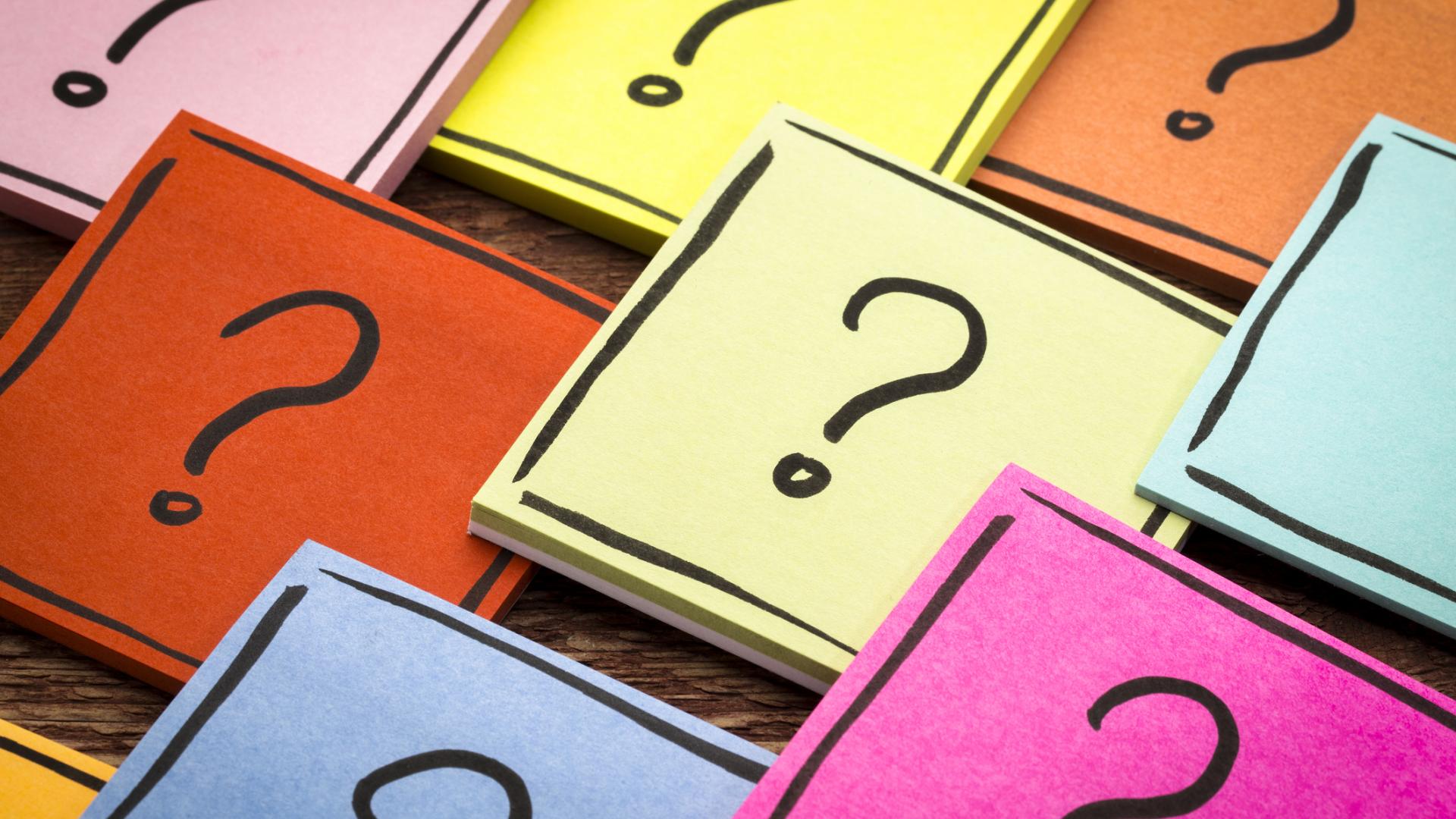 Photo of coloured squares with question marks laid on a table