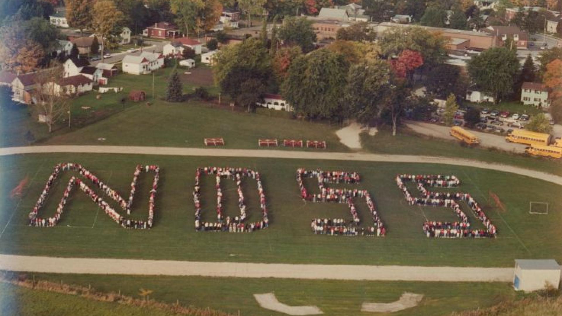 Areial view of students from Norwell District High School forming the letters N D S S in the 19990s