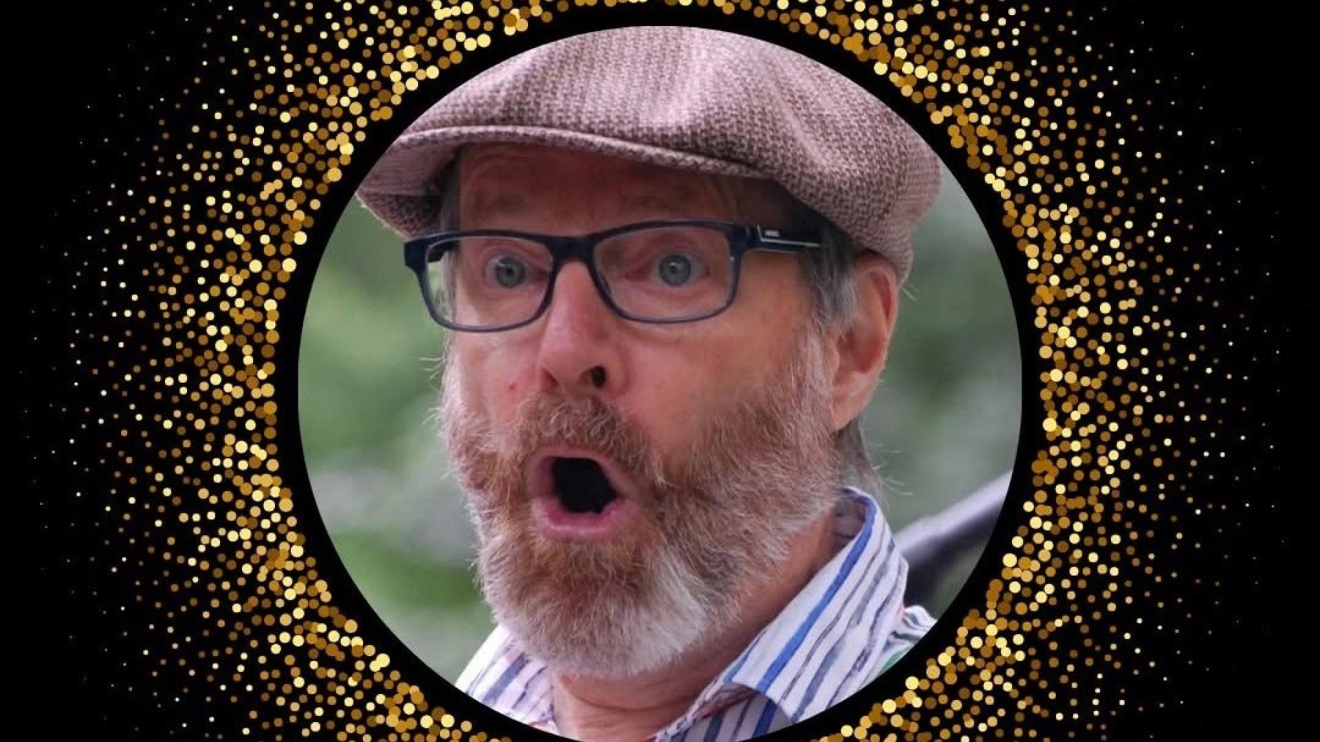 A photo of a man wearing a hat and glasses making an expression of surprise