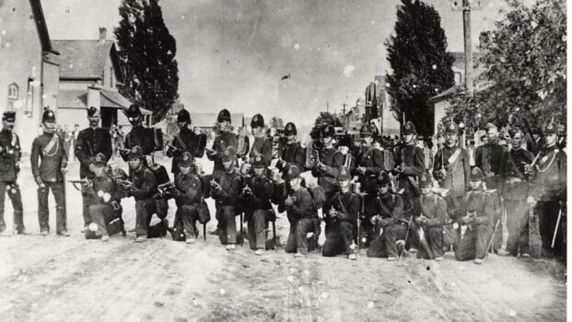 A historic photo of a troop of soldiers posing in the Main Street of Erin in 1915