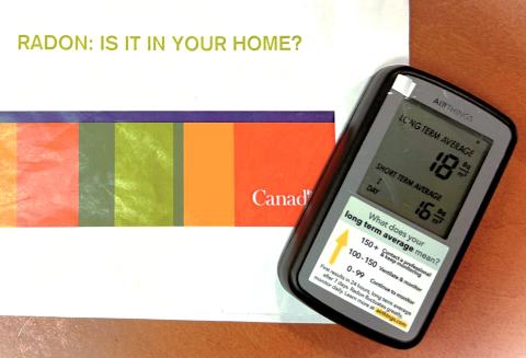 A rectangular device that monitors radon levels with short- and long-term averages and what your level of radon means