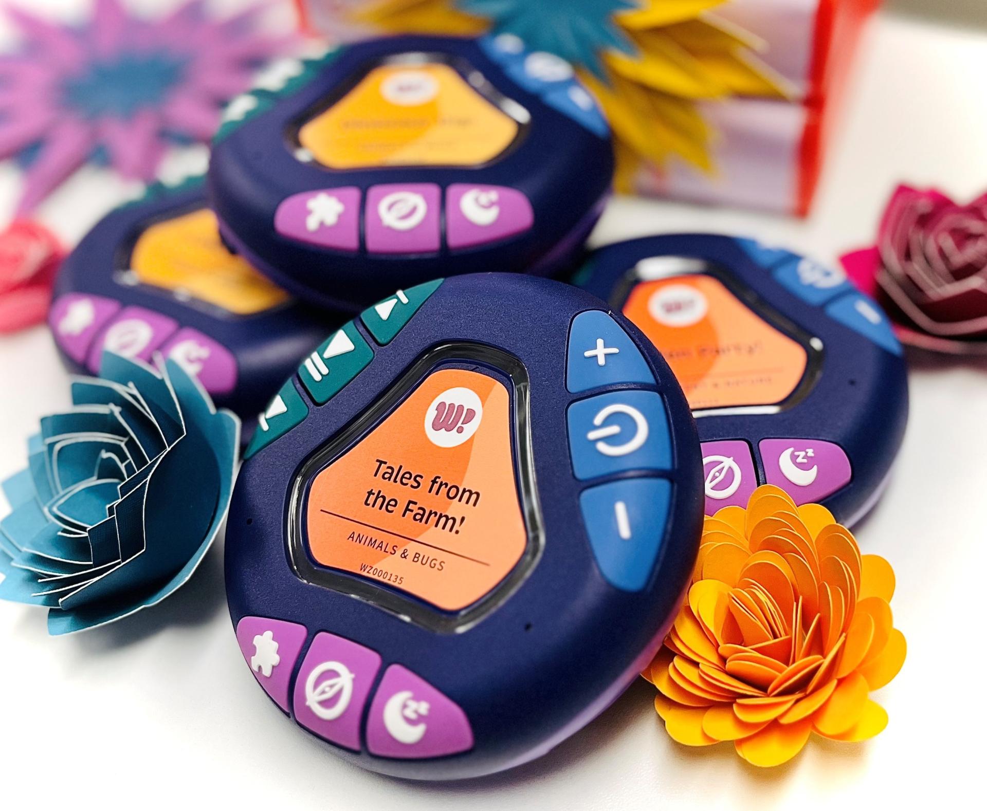 Small round electronic device with buttons and the words Tales from the Farm in the middle
